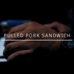 Man in North Face Jacket Making Pork Sandwich