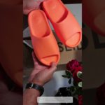 Really small Yeezy Slide Enflamed Orange and Pharrell Williams Chancletas HU Slides Unboxed