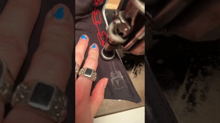 Person is freehand chainstitching a jacket using a 100-year-old embroidery machine!