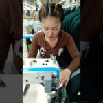 She is Sewing Jacket in Garment Factory