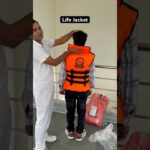 how to wear a life jacket 🛟 #lifejacket #jacket #rescue #flood #emergency #shortfeed #ytshorts