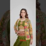 An olive green draped ensemble paired with a vibrant embroidered jacket.